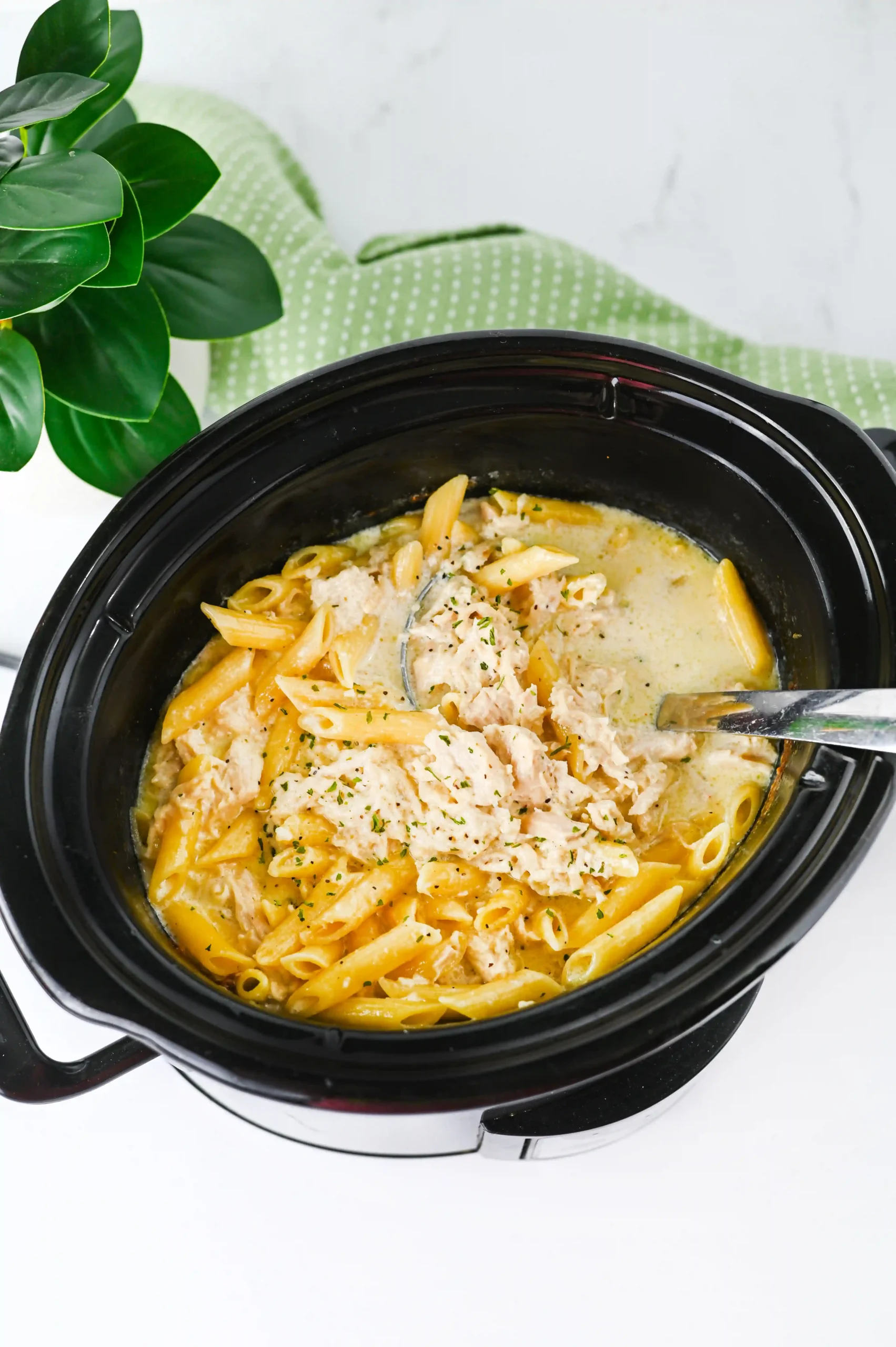 a crockpot with chicken Alfredo in it