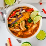 enchilada soup in a white bowl