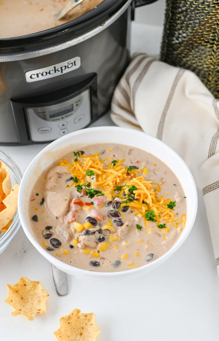 Cream Cheese Chicken Chili with cheese on top in a white bowl