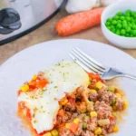 shepherd's pie on a white plate with a fork