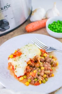 shepherd's pie on a white plate with a fork