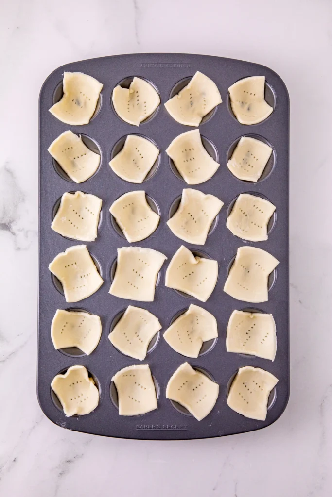 puff pastry squares in  a muffin tin