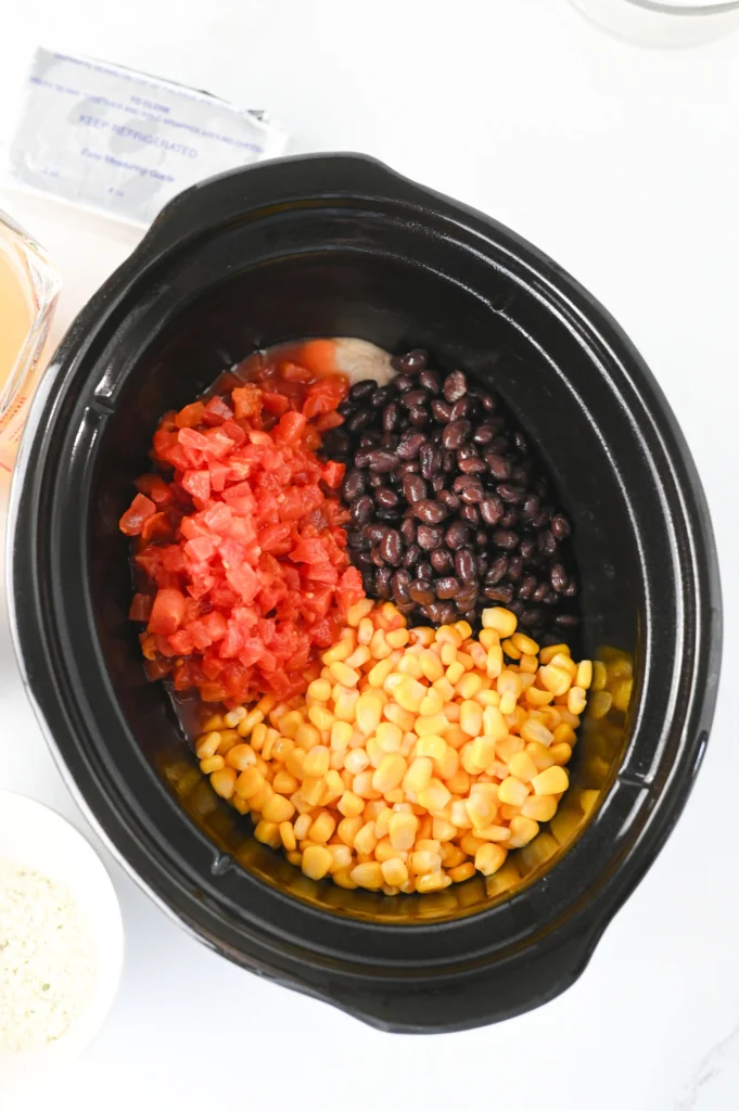 chicken, beans, tomatoes, and corn in a crockpot