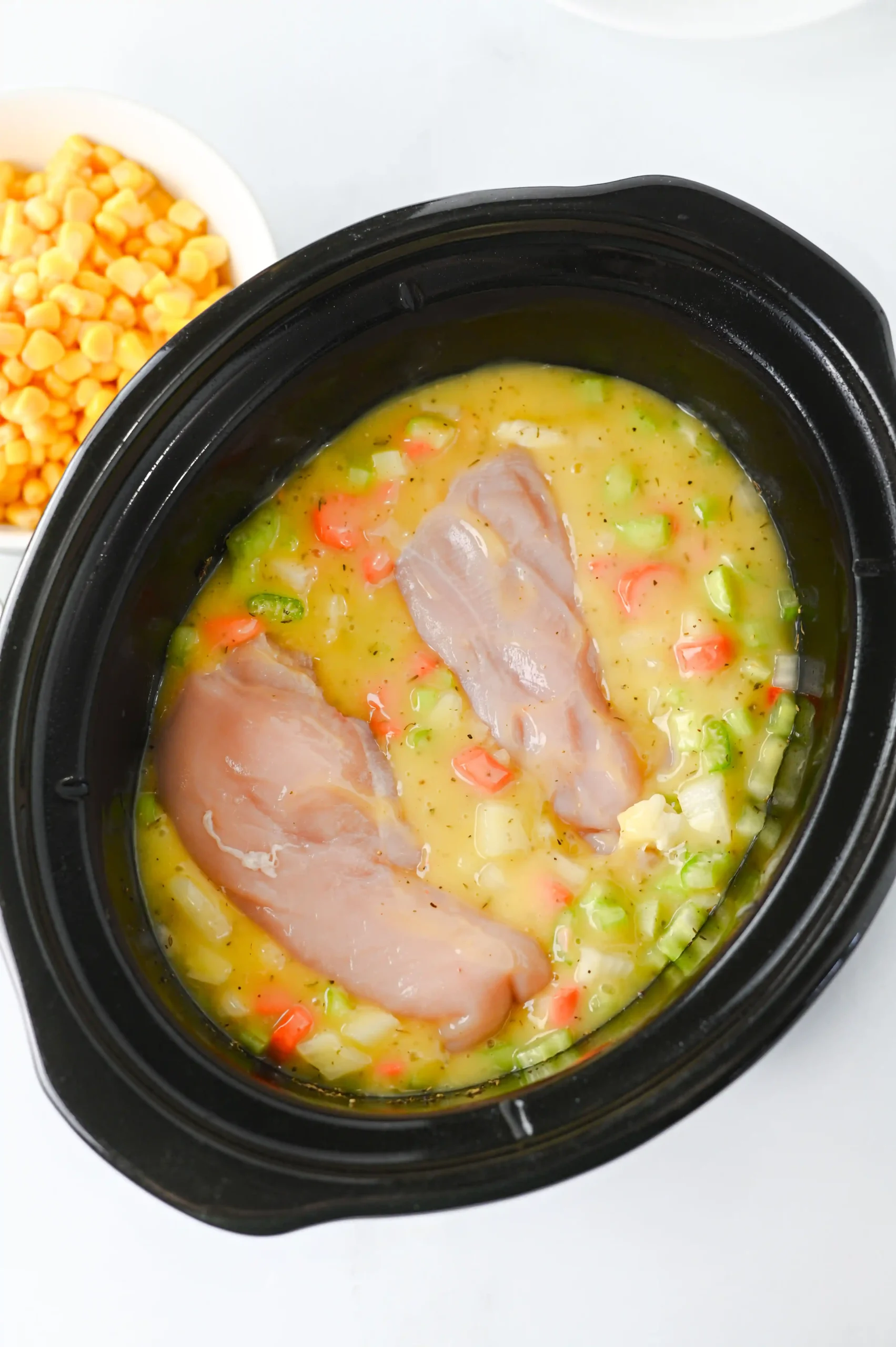 a crockpot filled with the ingredients for the crockpot chicken pot pie