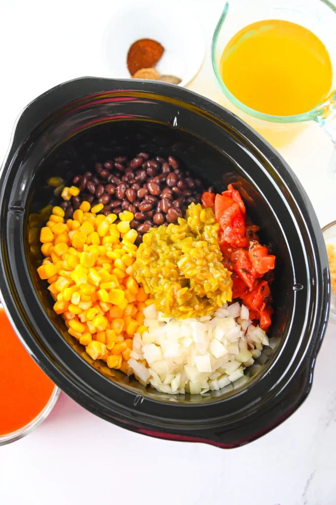 beans, corn, tomato, and chicken in a crockpot